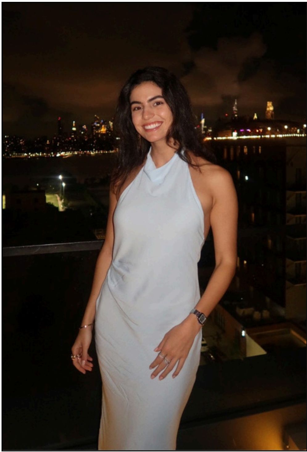 Portrait of Iara Saraiva on a balcony at night
